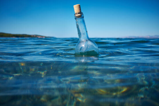 Message in a floating bottle in the ocean.