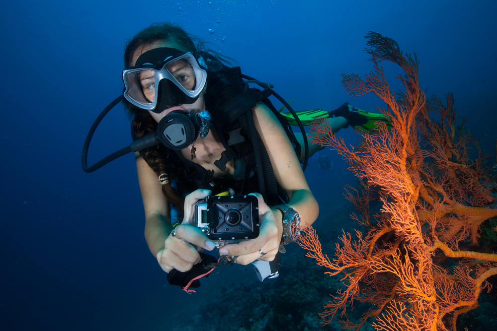 hot female scuba diver with gopro camera