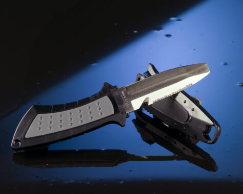 Dive,Knife,On,Black,And,Blue,Glass