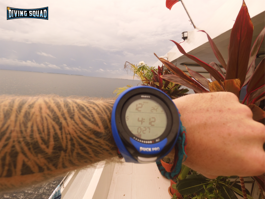 Mares Puck Pro on wrist on liveaboard in the Maldives.
