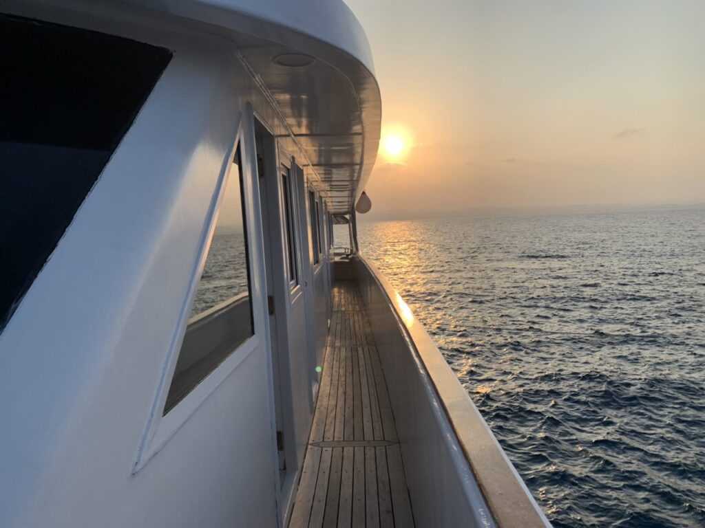 Seawolf Dominator Red Sea liveaboard with beautiful oceanic sunset behind.
