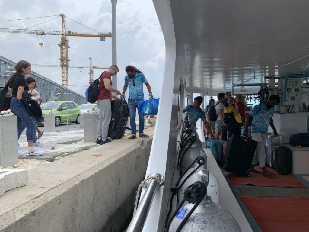 Guests with baggage boarding liveaboard.