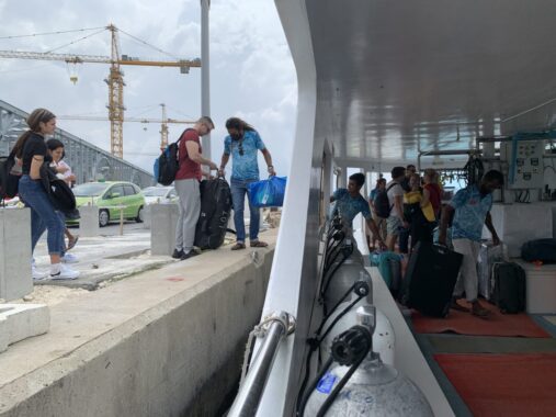 Guests with baggage boarding liveaboard.