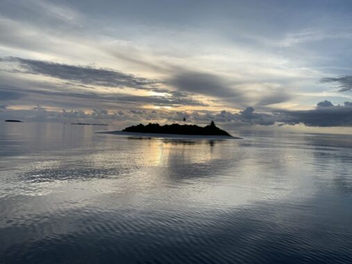 Maldivian island at sunset during liveaboard trip.