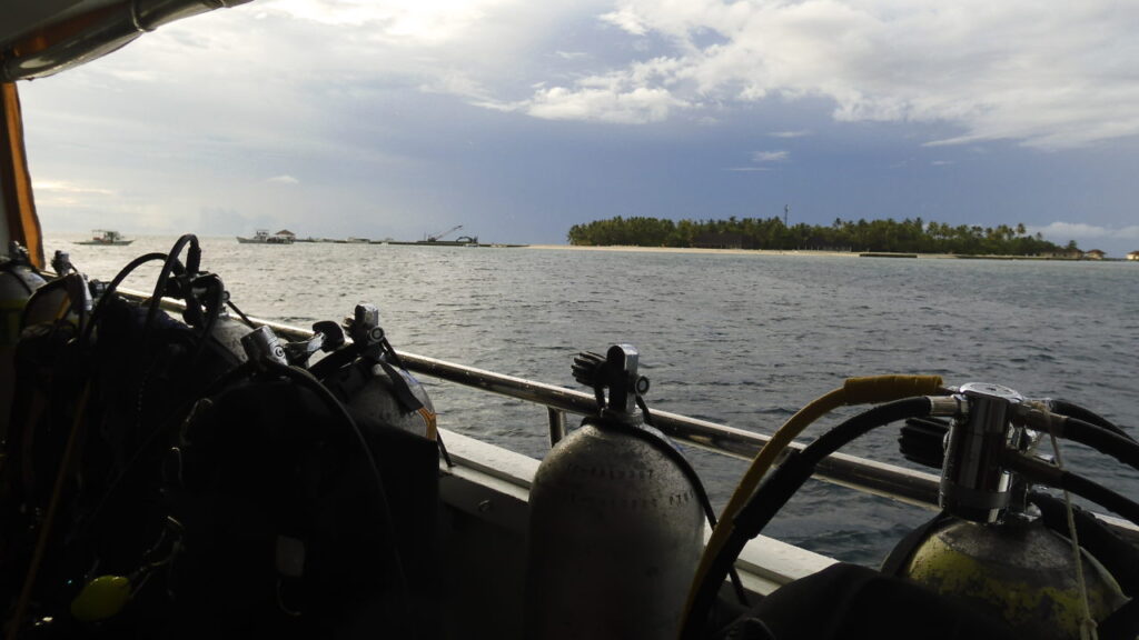 Scuba tanks and bcd's on Donny with Maldivian island in background.