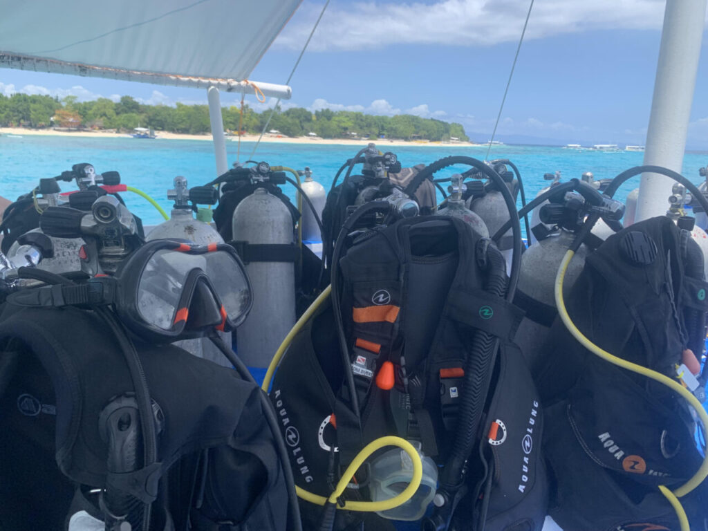 Scuba diving gear on dive boat headed to Bohol dive site.