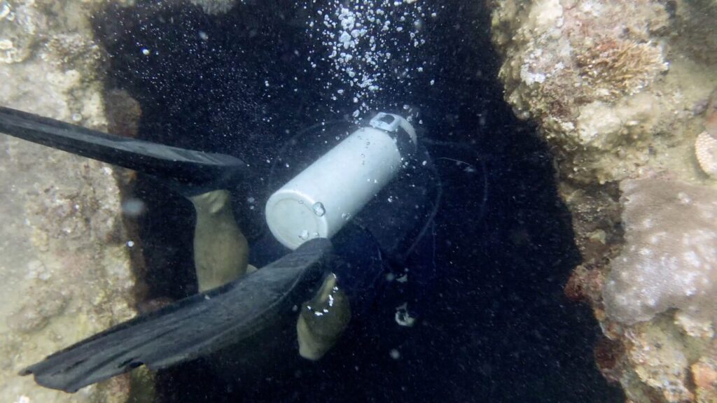 Scuba diver entering wreck dive site of Coron bay.