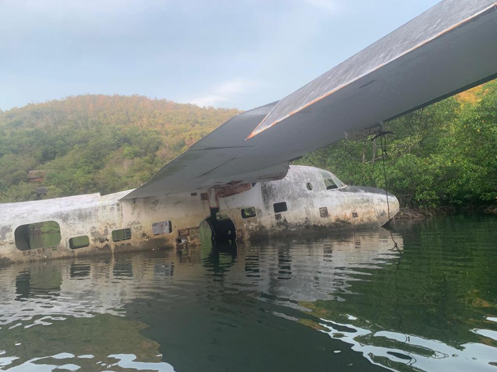 Abandoned sea plane partially submerged in waters of El Nido