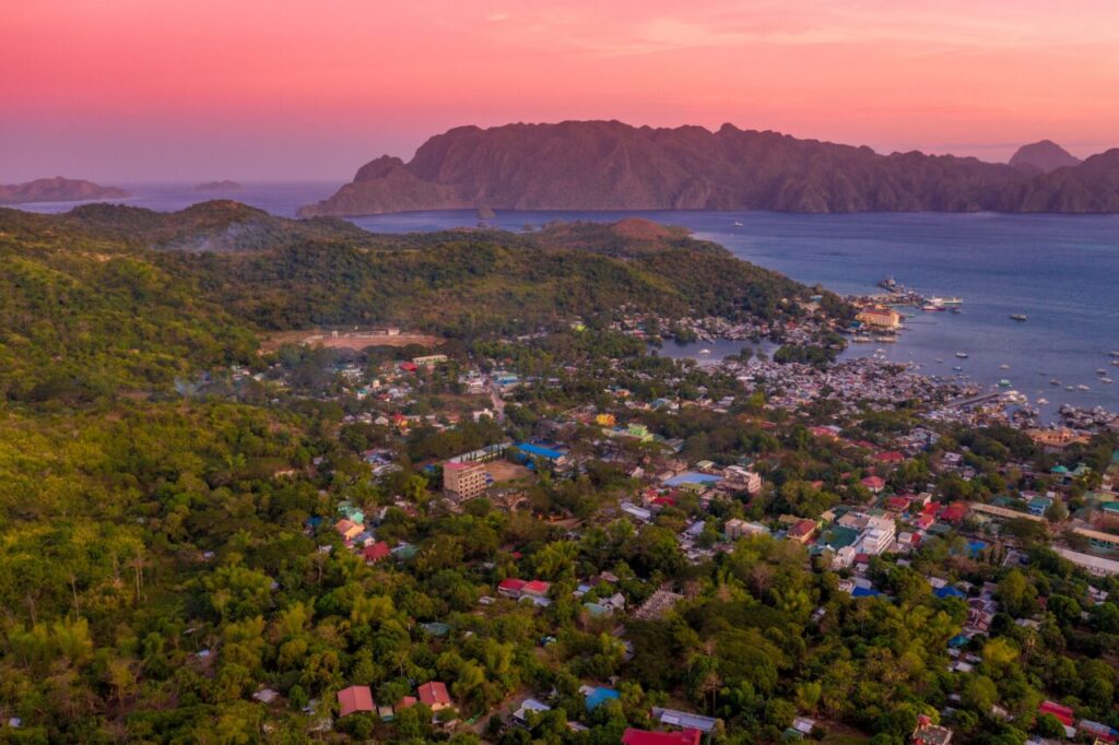 Coron Town at sunset with resorts and hostels.