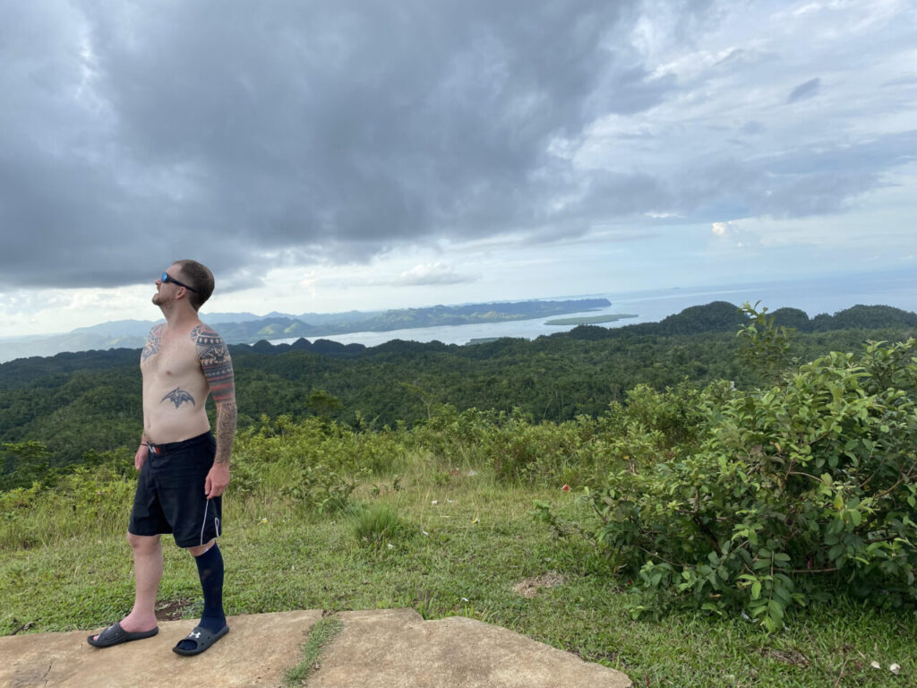 Awesome looking dude standing against Blue Heaven Viewpoint of Anda.