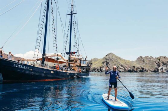 Guest paddleboarding next to Adeelar