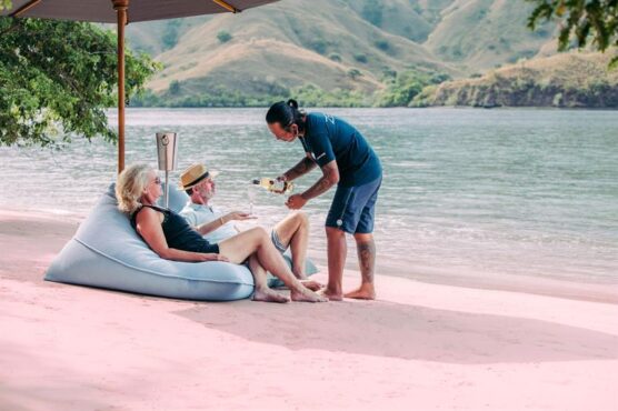 Guests served drinks on beautiful secluded beach during scubaspa zen trip.
