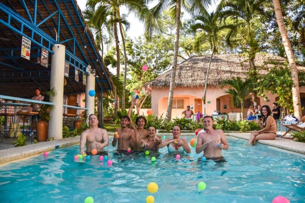 Travellers in swimming pool of Mad Monkey Backpackers Hostel