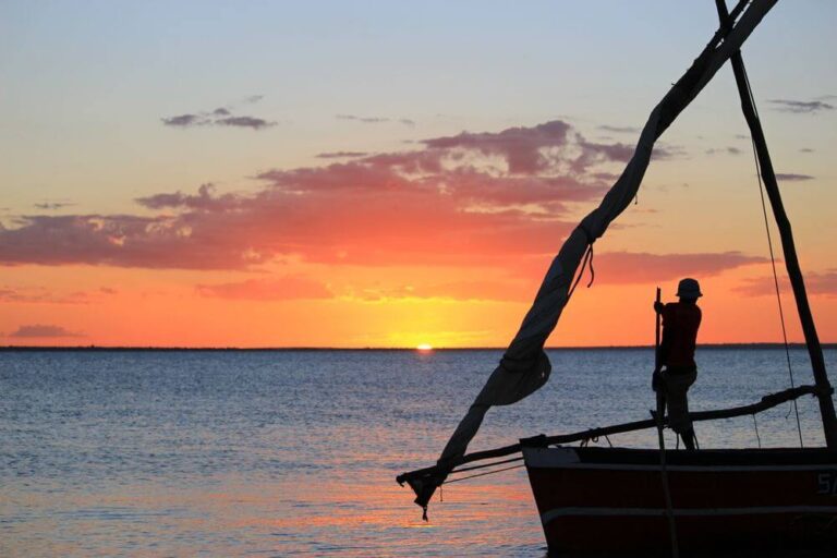 diver in a boat sunset