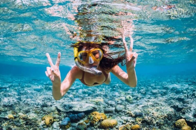 buying guide - happy young woman snorkeling.