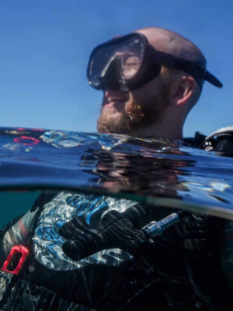 Alex (me) of Diving Squad smiling at the surface of the water after guiding a dive at Panglao.