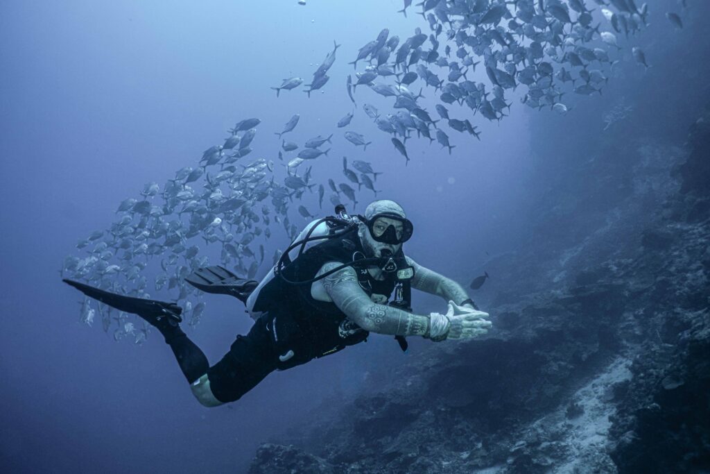 Alex scuba diving with tornado of Jacks at Napaling.